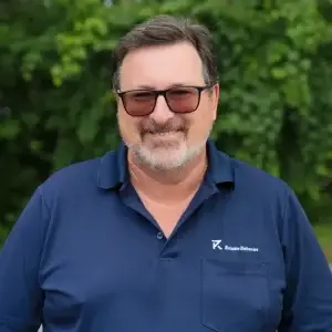Colin, a Niagara courier company owner, is the founder of Reliable Deliveries, wearing sunglasses in the company uniform.